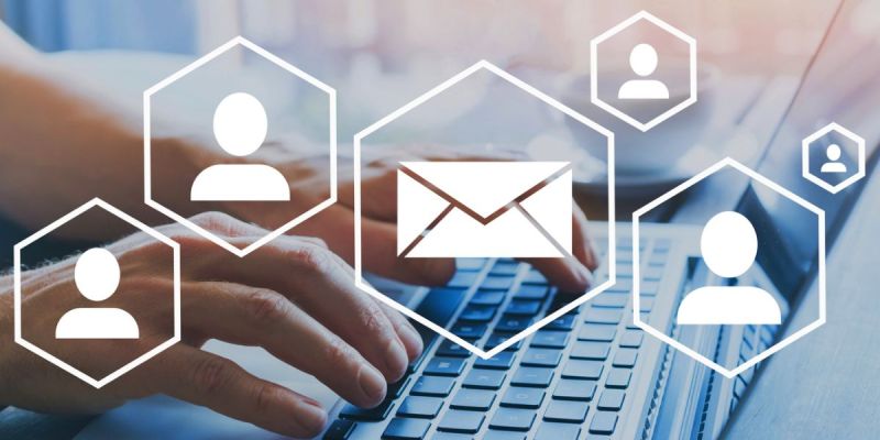 A hand on a keyboard sending an email